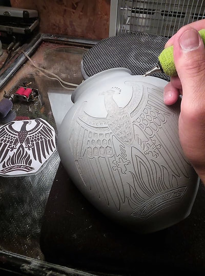 tattooing a clay Phoenix