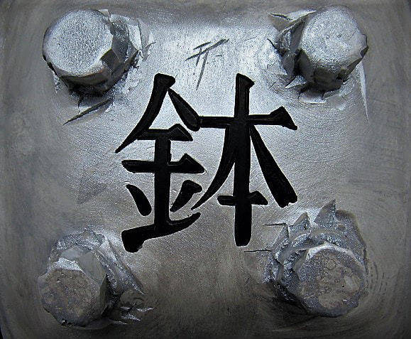 kanji writing on the bottom of a ceramic bonsai pot